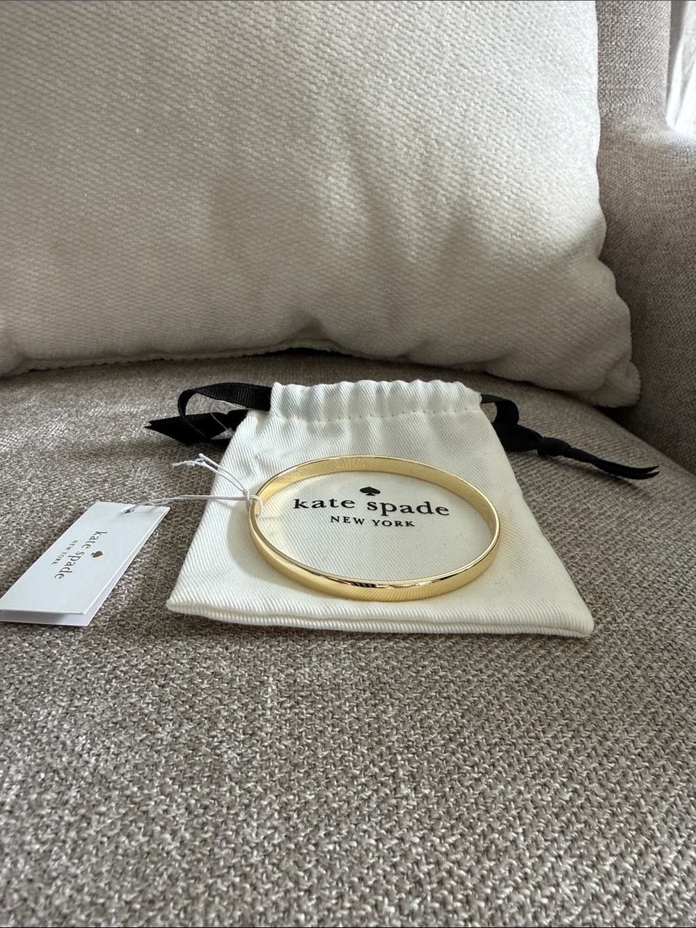 Kate Spade gold costume bangle. Would fit small to medium wrist.